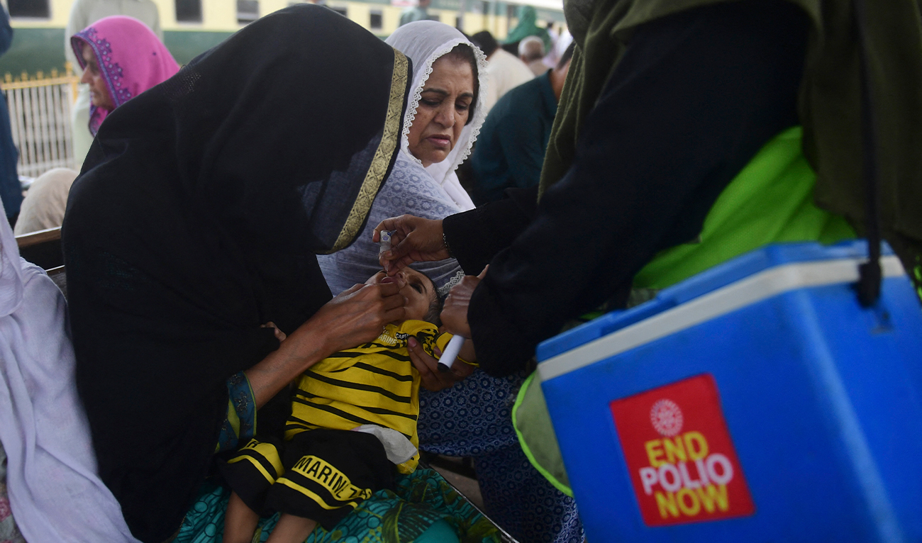 A health worker administers polio vaccine drops to a child at a railway station during a vaccination campaign in Karachi on March 14, 2023. (Photo courtesy: AFP/File)