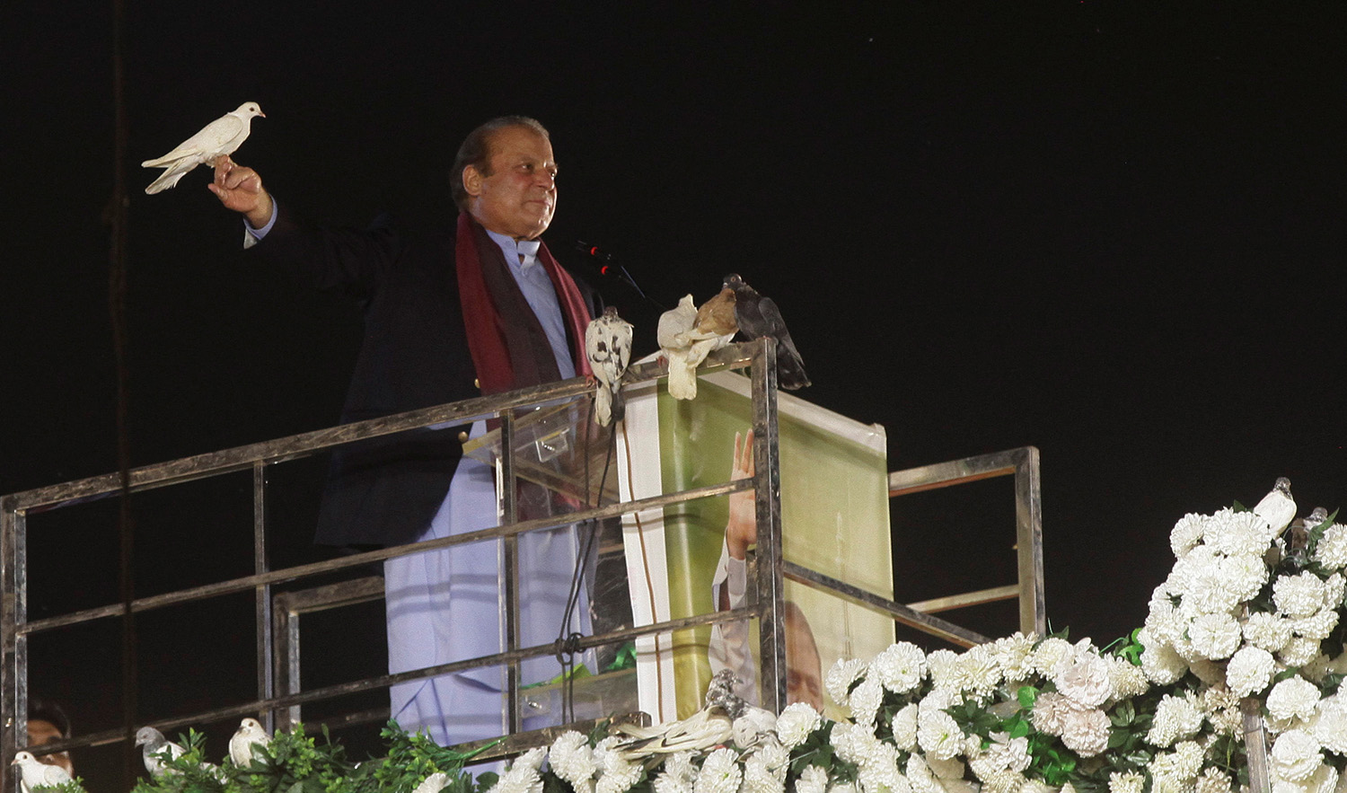 Pakistan's former Prime Minister Nawaz Sharif prepares to release a pigeon in front of supporters, following his arrival from a self-imposed exile in London, ahead of the 2024 Pakistani general election, in Lahore, Pakistan, October 21, 2023. (REUTERS)
