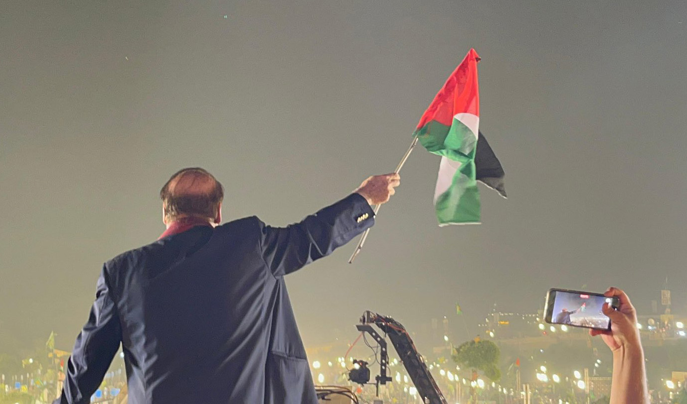 Former Pakistan Prime Minister Nawaz Sharif holds Palestinian flag during his rally in Lahore, Pakistan on October 22, 2023. (Photo courtesy: Pakistan Muslim League-Nawaz)