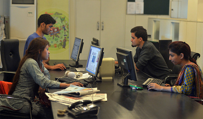 Pakistani staff of Islamabad-based Power 99 FM radio work on their computers at the radio station's office in Islamabad on July 26, 2016. (AFP/File)
