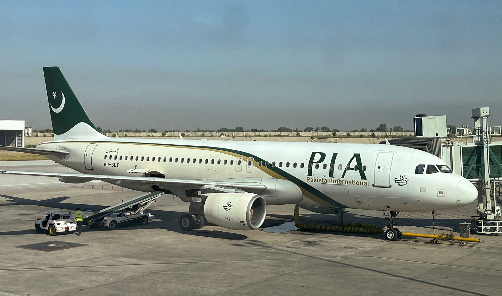 View of a Pakistan International Airlines (PIA) passenger plane, taken through a glass panel, at Islamabad International Airport, Pakistan on October 3, 2023. (REUTERS)