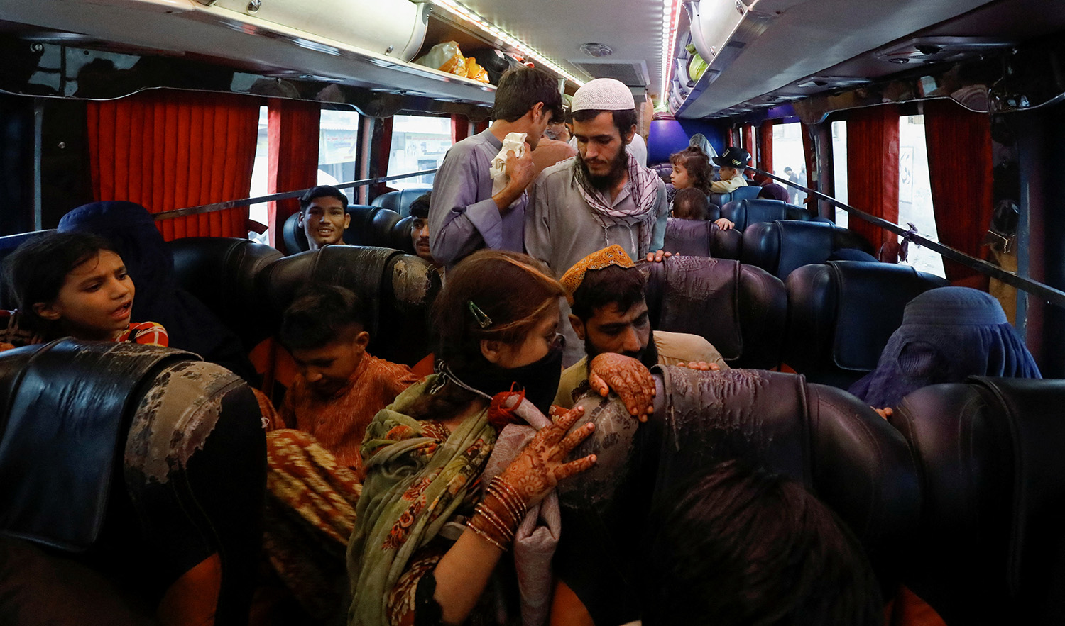 Afghan people walk on a bus as they wait to return home, after Pakistan gave the last warning to undocumented migrants to leave, at a bus stop in Karachi, Pakistan on October 25, 2023. (REUTERS)