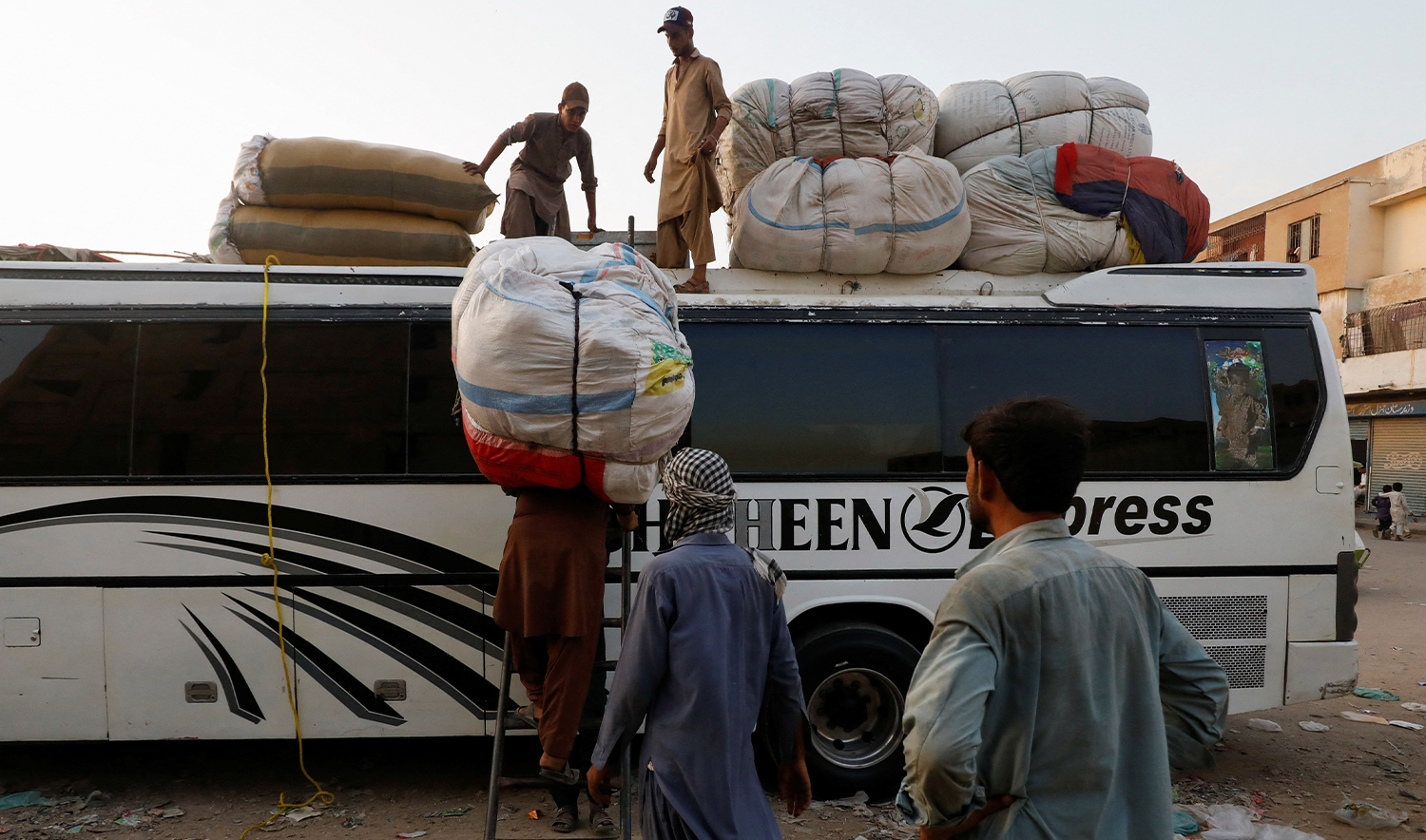 Afghan men load their belongings as they prepare to return home, after Pakistan gave the last warning to undocumented migrants to leave, at a bus stop in Karachi, Pakistan on October 25, 2023. (REUTERS/File)