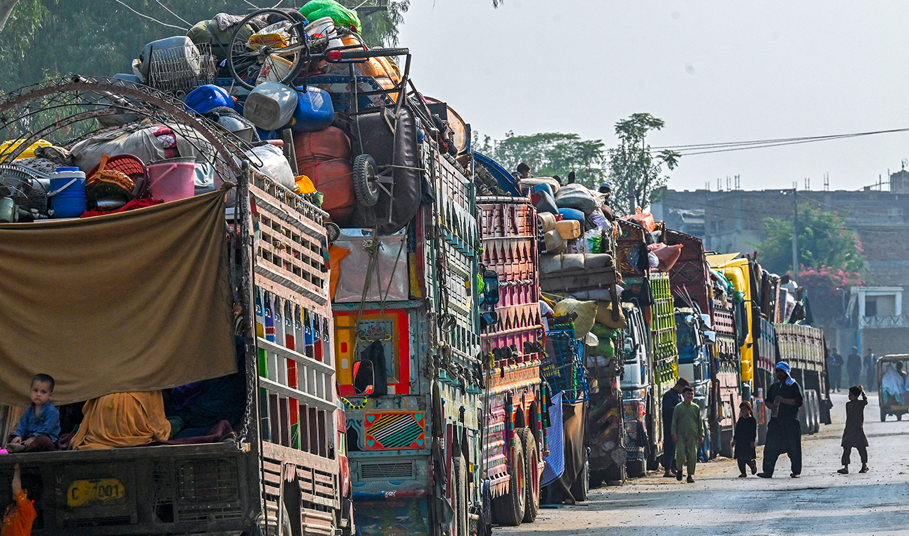 Afghan refugees in trucks wait near the United Nations High Commissioner for Refugees (UNHCR) Azakhel Voluntary Repatriation Centre in Nowshera on October 30, 2023. (AFP)