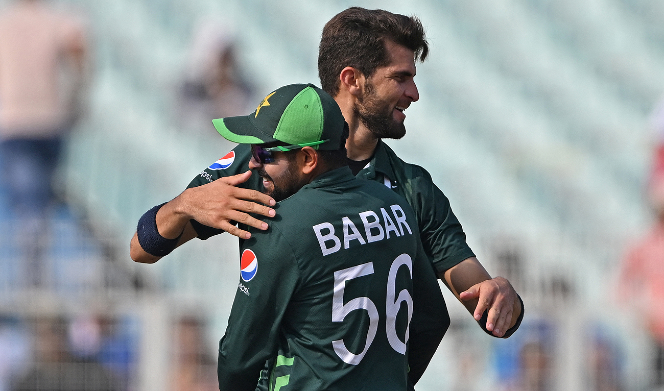 Pakistan's Shaheen Shah Afridi (R) celebrates with captain Babar Azam after taking the wicket of Bangladesh's Tanzid Hasan during the 2023 ICC Men's Cricket World Cup one-day international (ODI) match between Pakistan and Bangladesh at the Eden Gardens in Kolkata on October 31, 2023. (AFP)