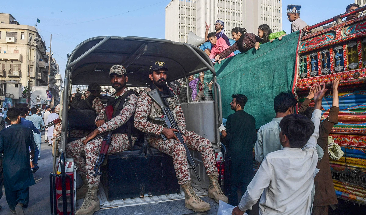 Paramilitary soldiers patrol as Muslim devotees take part in a rally to celebrate the birthday anniversary of Prophet Muhammad (PBUH), in Karachi, Pakistan on September 29, 2023. (AFP)