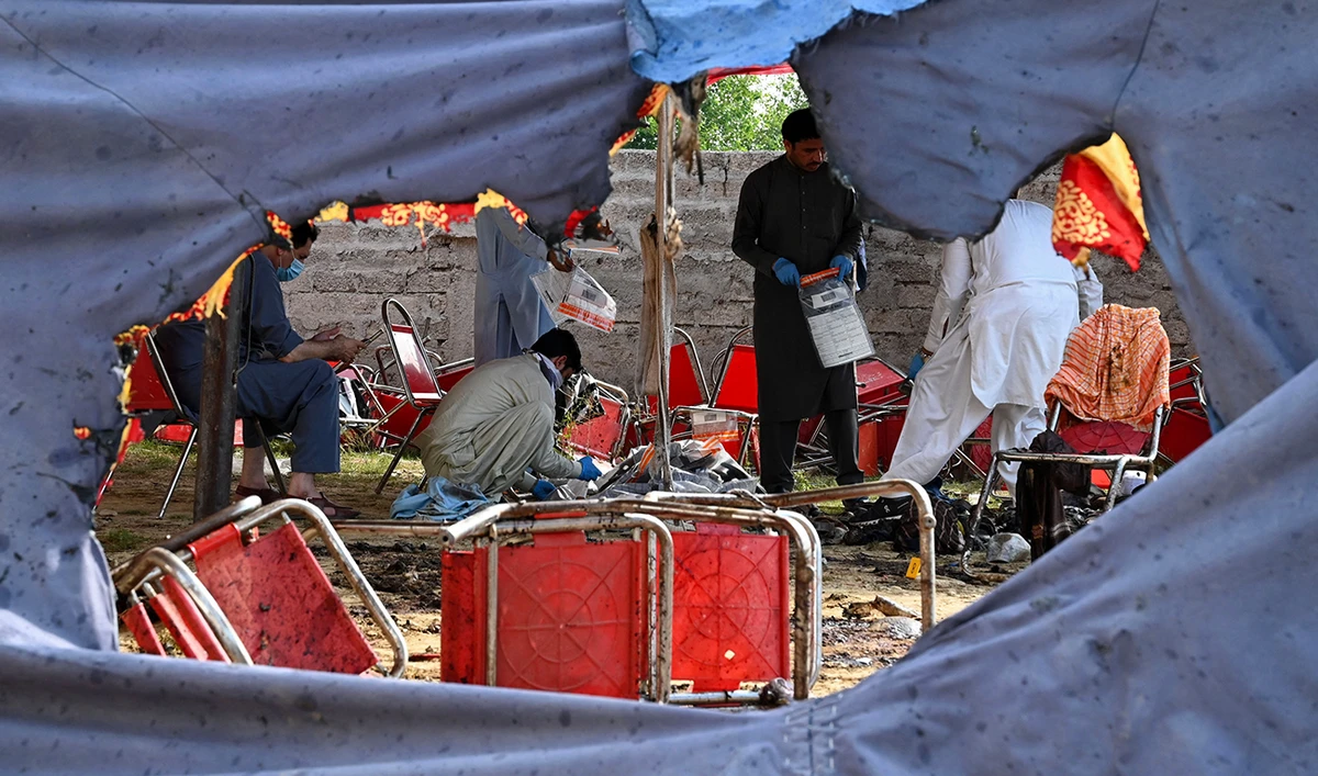 Police officials examine the site of a bomb blast in Bajaur district of Khyber-Pakhtunkhwa province on July 31, 2023. (AFP/File)