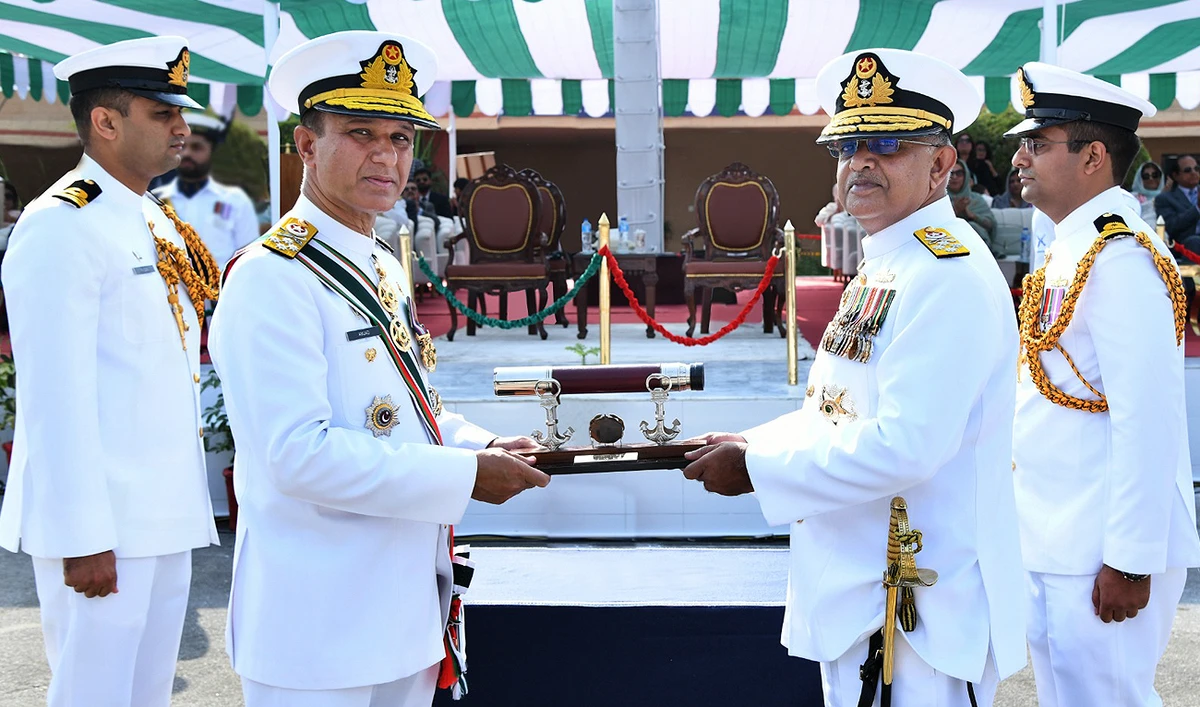 In this handout photograph, taken and released by the Pakistan Navy, the outgoing Pakistan Navy chief Admiral Muhammad Amjad Khan Niazi (left) handing over command of the Pakistan Navy to Admiral Naveed Ashraf (right) during the change of command ceremony at the PNS Zafar in Islamabad on October 7, 2023. (Photo courtesy: Pakistan Navy)