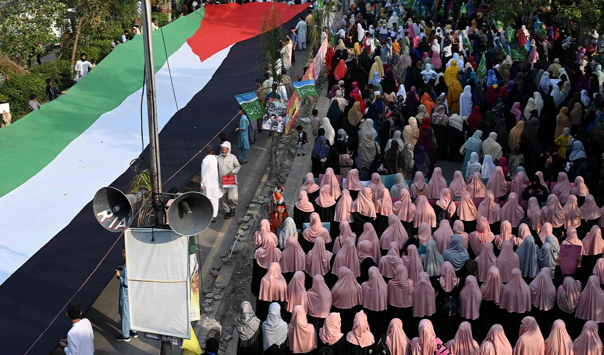 Supporters of Pakistan's Islamist political party Jamaat-e-Islami take part in a rally to show solidarity with Palestinians, in Lahore on October 13, 2023. (AFP)