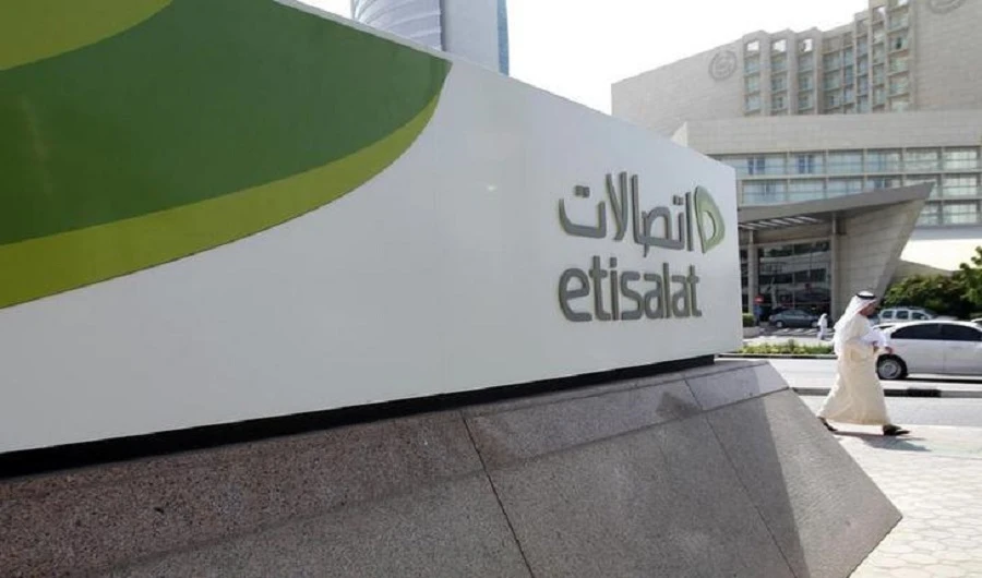 A man walks past a sign at the headquarters of telecommunications company Etisalat in Dubai on October 25, 2011. (REUTERS/File)