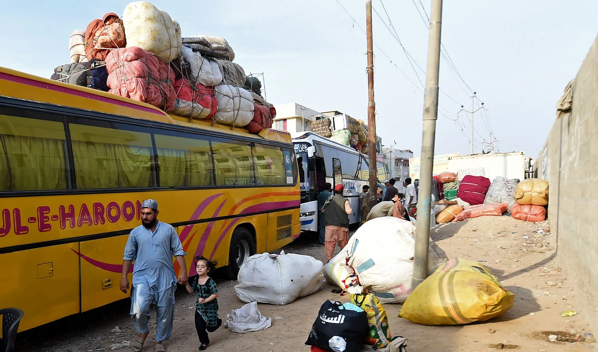 Pakistan's Afghan refugees load their belongings onto a bus at the Karachi bus terminal in Sindh province for their departure to Afghanistan on October 27, 2023. (AFP)