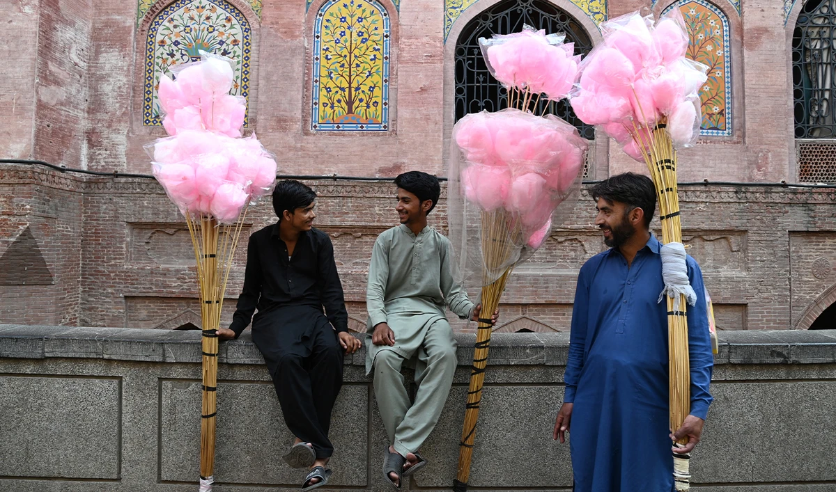 Cotton candy sellers wait for customers outside the Wazir Khan mosque in Lahore on October 20, 2023. (AFP/File)