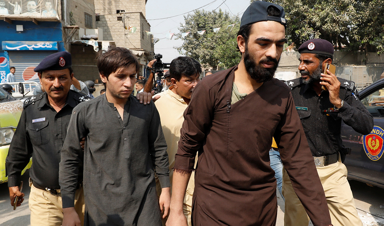 Afghan nationals, who according to police were undocumented, walk as they are detained and shifted to a holding centre, after Pakistan gave the last warning to undocumented migrants to leave, in Karachi, Pakistan November 1, 2023. (Reuters)