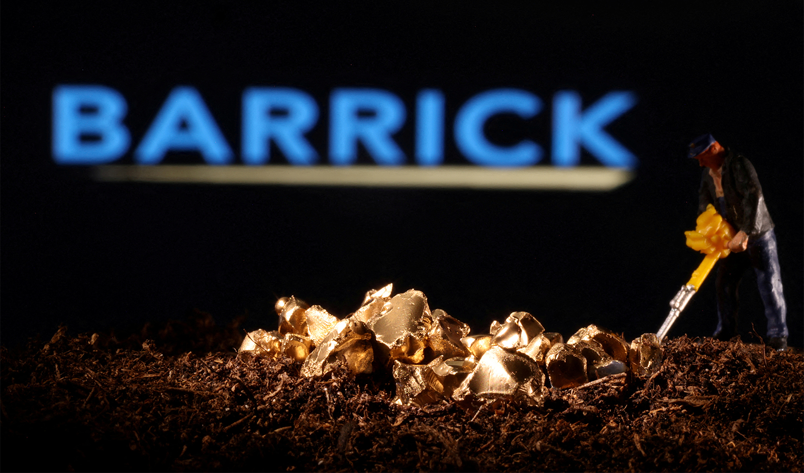A small toy figure and gold imitation are seen in front of the Barrick logo in this illustration taken November 19, 2021. (REUTERS)