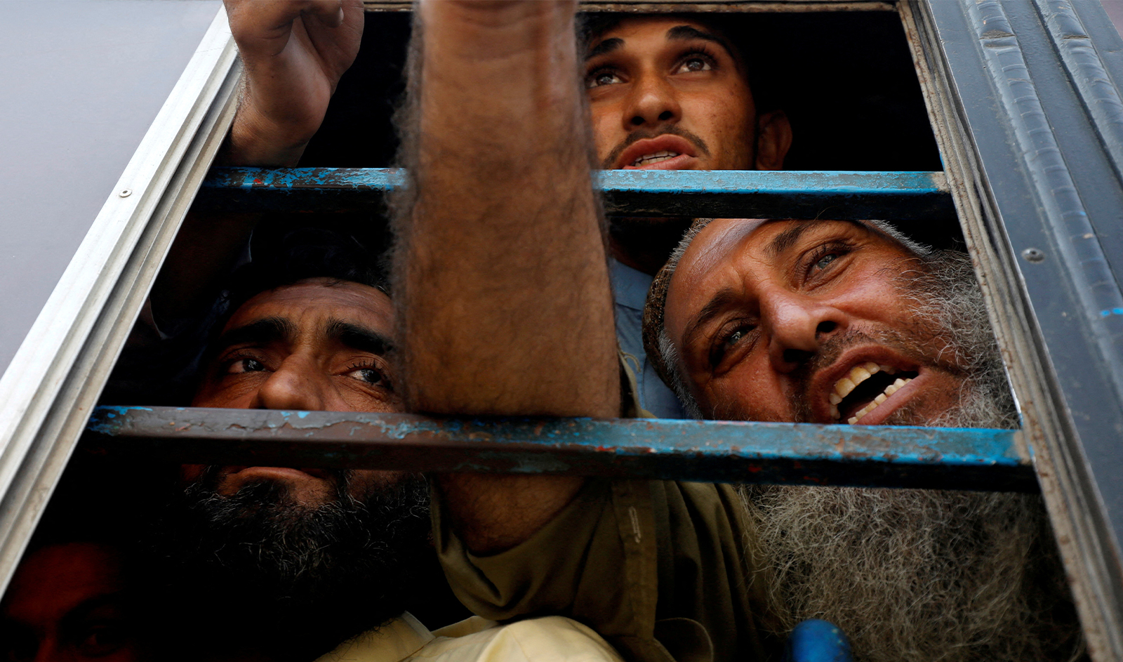Afghan nationals, who according to police were undocumented, speak to the members of the media from the window of a bus, as they were detained and shift to a temporary holding centre, after Pakistan gave the last warning to undocumented migrants to leave, in Karachi, Pakistan on November 2, 2023. (REUTERS)
