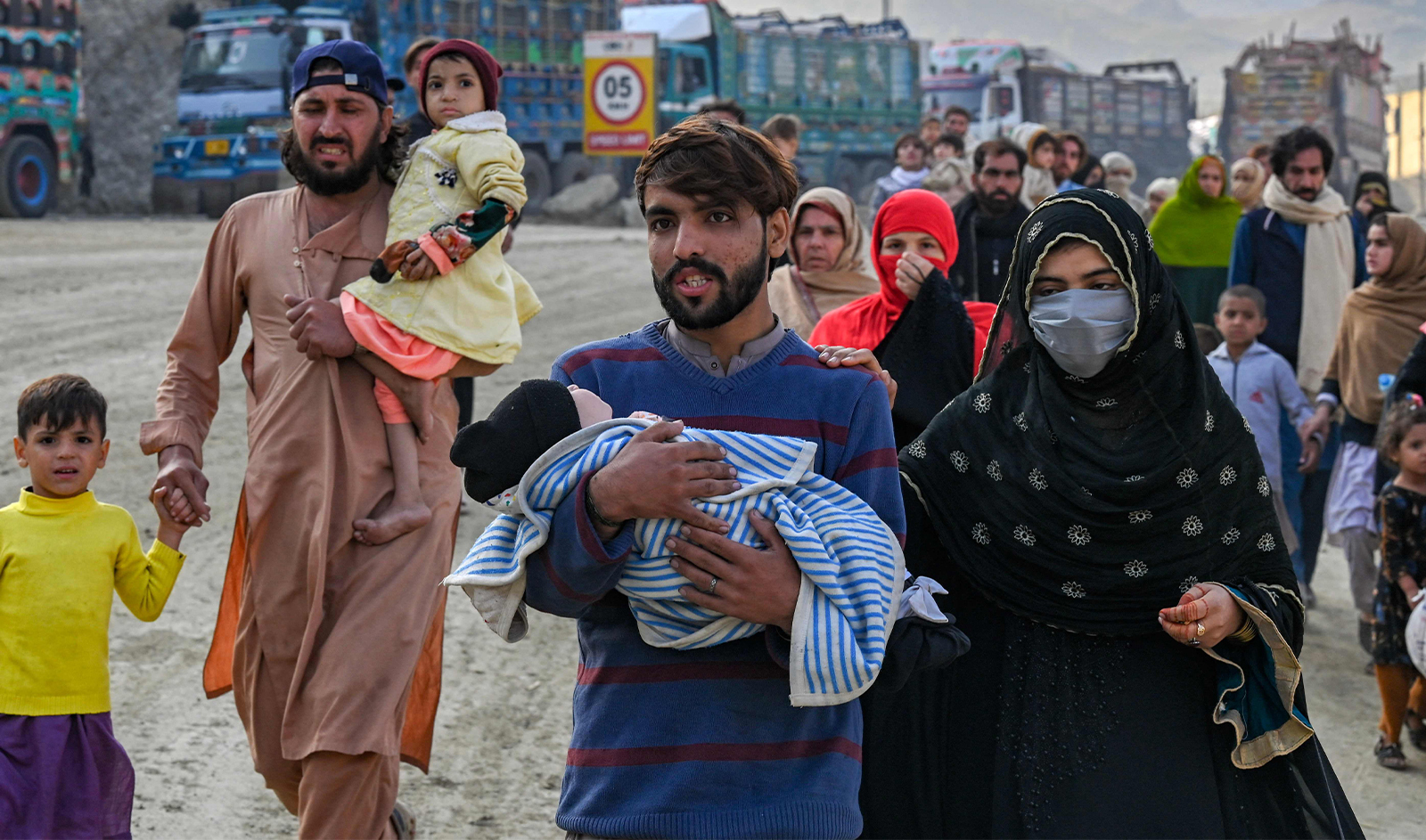 Afghan refugees in Pakistan walk towards the Pakistan-Afghanistan Torkham border on November 3, 2023, following Pakistan's government decision to expel people illegally staying in the country. More than 165,000 Afghans have fled Pakistan since Islamabad issued an ultimatum to 1.7 million people a month ago to leave or face arrest and deportation, officials said on November 2. (AFP)