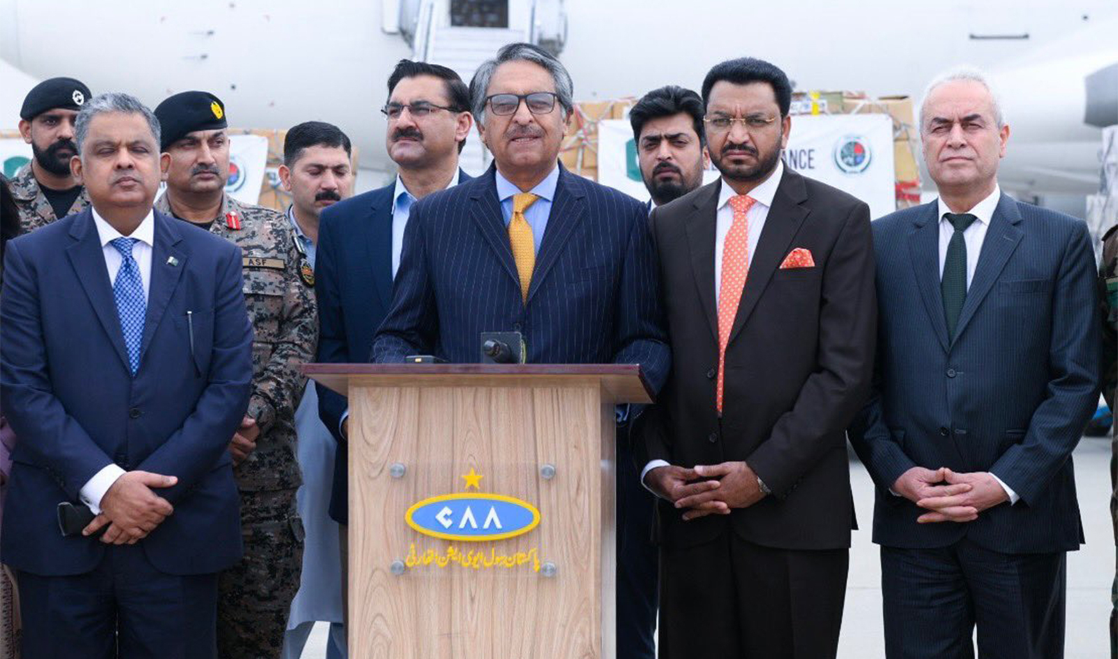 Pakistan’s caretaker foreign minister, Jalil Abbas Jilani (2L), is seen addressing the media along with the Palestinian ambassador, Ahmed Jawad A.A. Rabaei (R), as the country dispatches second aid consignment for Gaza from Islamabad, Pakistan, on November 7, 2023. (Radio Pakistan)