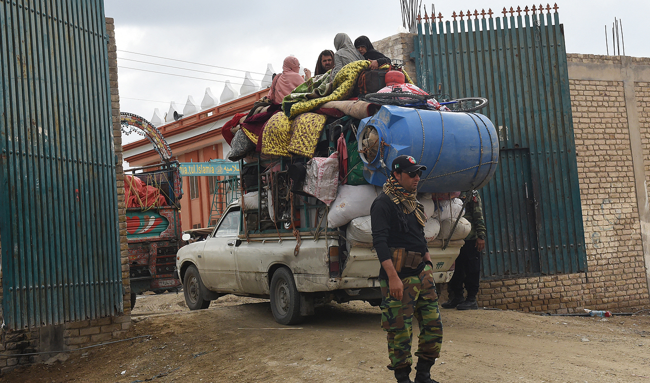 Afghan refugees arrive on the back of a vehicle at a holding center before crossing the Pakistan-Afghanistan border in Chaman on November 7, 2023, following Pakistan's government decision to expel people illegally staying in the country. (AFP)