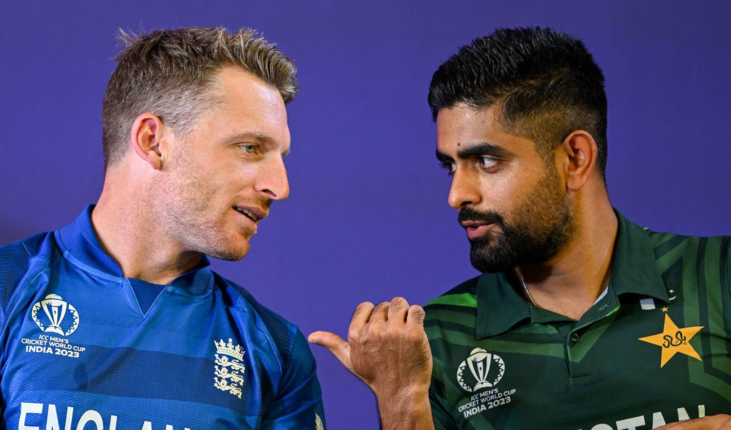 Pakistan's captain Babar Azam (R) speaks with his England counterpart Jos Buttler during the 'Captains' Day event' an interaction session between the captains of all participating teams and the media at the Narendra Modi Stadium in Ahmedabad on October 4, 2023. (AFP/File)