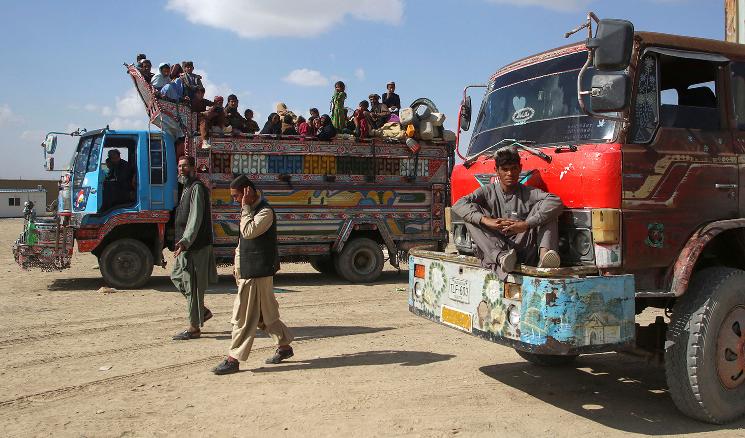 Afghan men walk as a family boards a truck as they head back to Afghanistan from Pakistan, at the Chaman Border Crossing along the Pakistan-Afghanistan Border in Balochistan Province, in Chaman, Pakistan November 9, 2023. (REUTERS)
