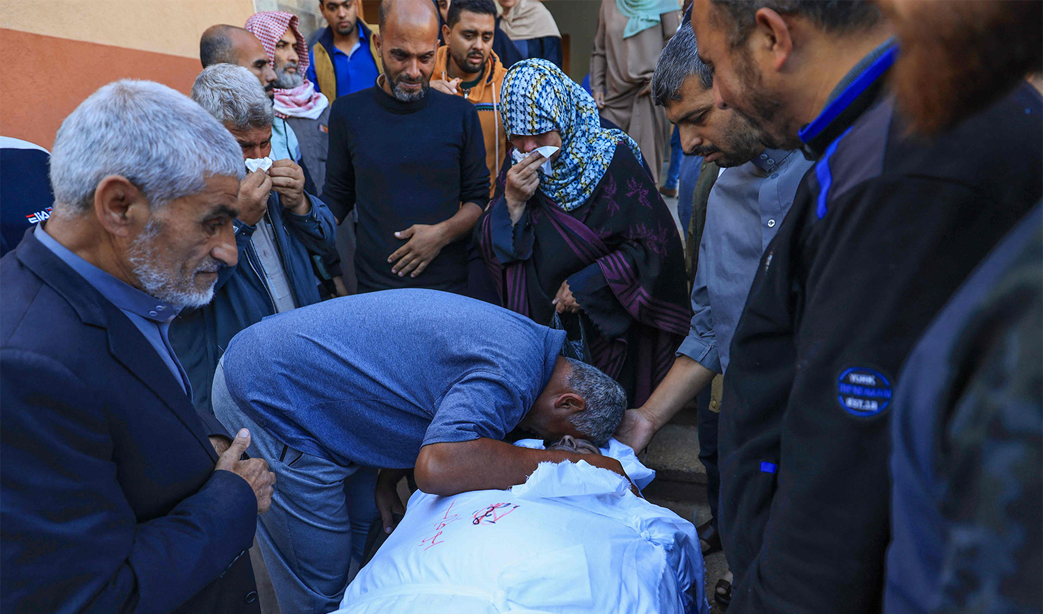 Palestinians mourn over a body ready for burial in Khan Yunis in the southern Gaza Strip on November 16, 2023. (AFP)