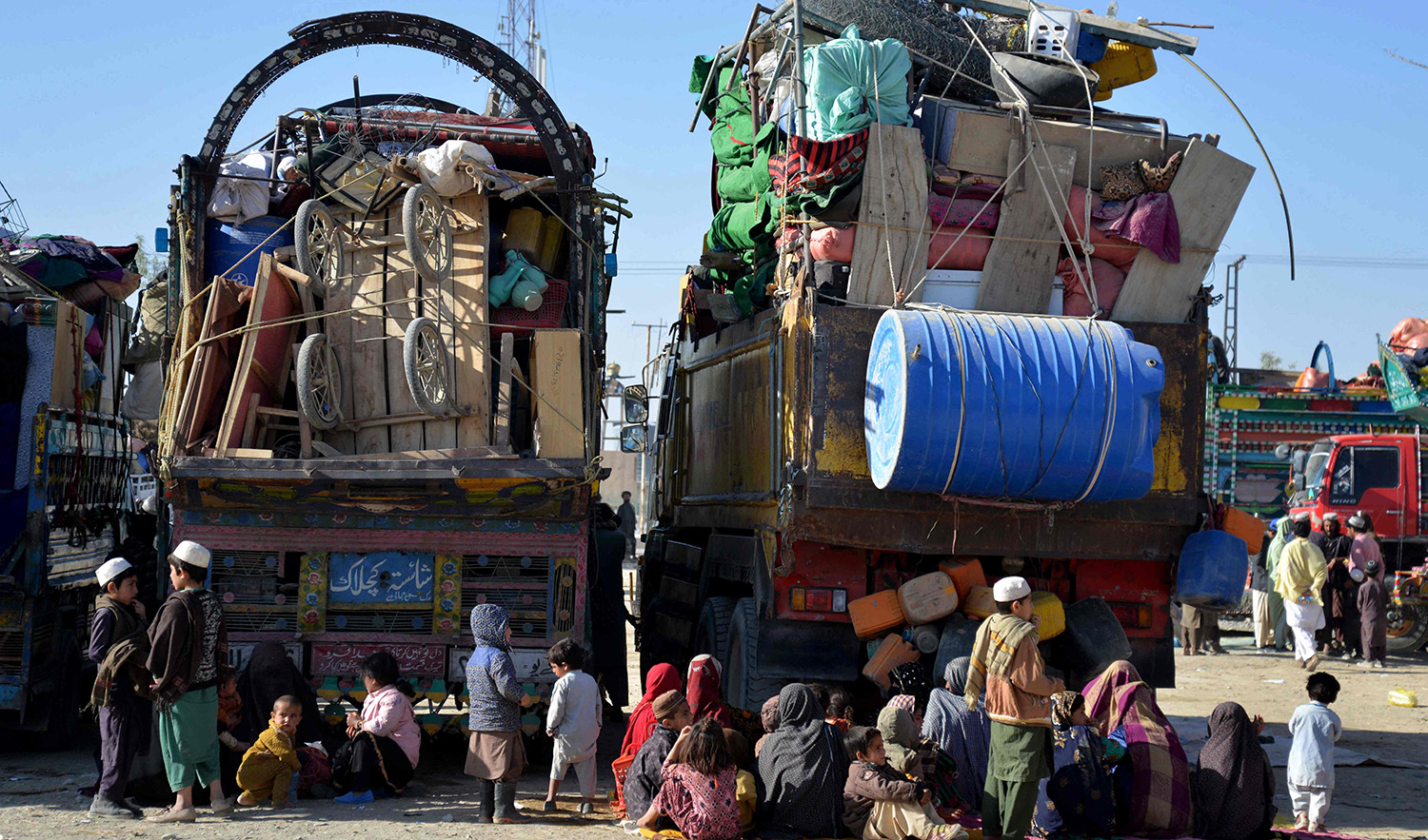 Afghan refugees sit beside their belongings at a registration centre upon their arrival from Pakistan, near the Afghanistan-Pakistan border in the Spin Boldak district of Kandahar province on November 20, 2023. (AFP)