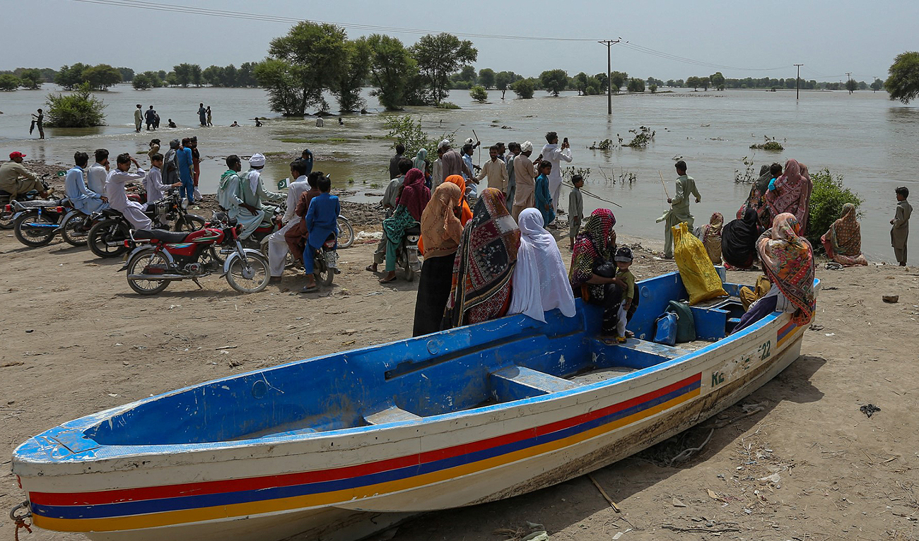In this file photo, taken on August 27, 2023, flood affected people gather on high ground at a flooded area of Burewala, a town of southern Punjab province. (AFP/File)