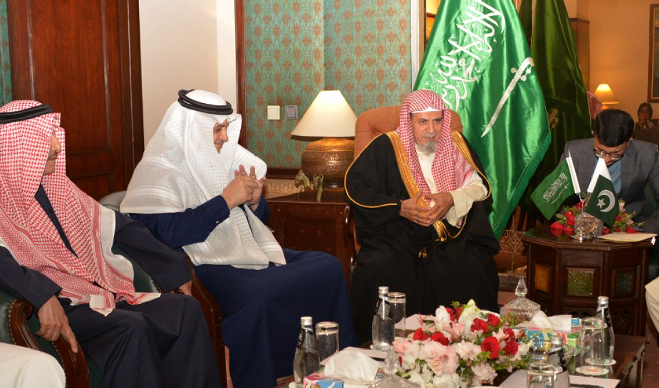 This handout photo, taken and released by Government of Pakistan, shows Imam-e-Kaaba Sheikh Saleh bin Humaid (right) and Saudi Ambassador to Pakistan Nawaf bin Said Al-Malki (2nd right) during a meeting with Education Minister Madad Ali Sindhi (not pictured) in Islamabad on November 22, 2023. (Photo courtesy: GOP)