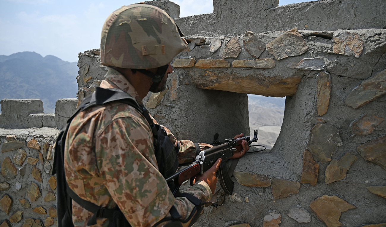 In this file photo, taken on August 3, 2021, a Pakistani army soldier mans a position at the Pakistan-Afghanistan border near Big Ben post in Khyber district in Khyber Pakhtunkhwa province. (AFP/File)