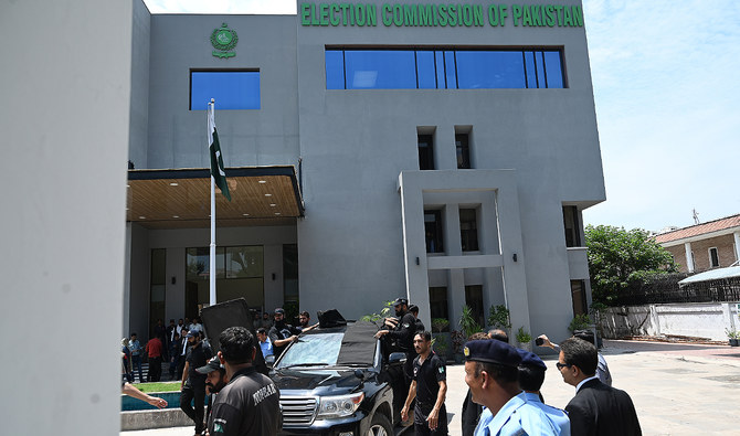 In this file photo, taken on July 25, 2023, security personnel escort a vehicle carrying Pakistan’s former Prime Minister Imran Khan (C) as he leaves after appearing before the Election Commission in Islamabad. (AFP/File)