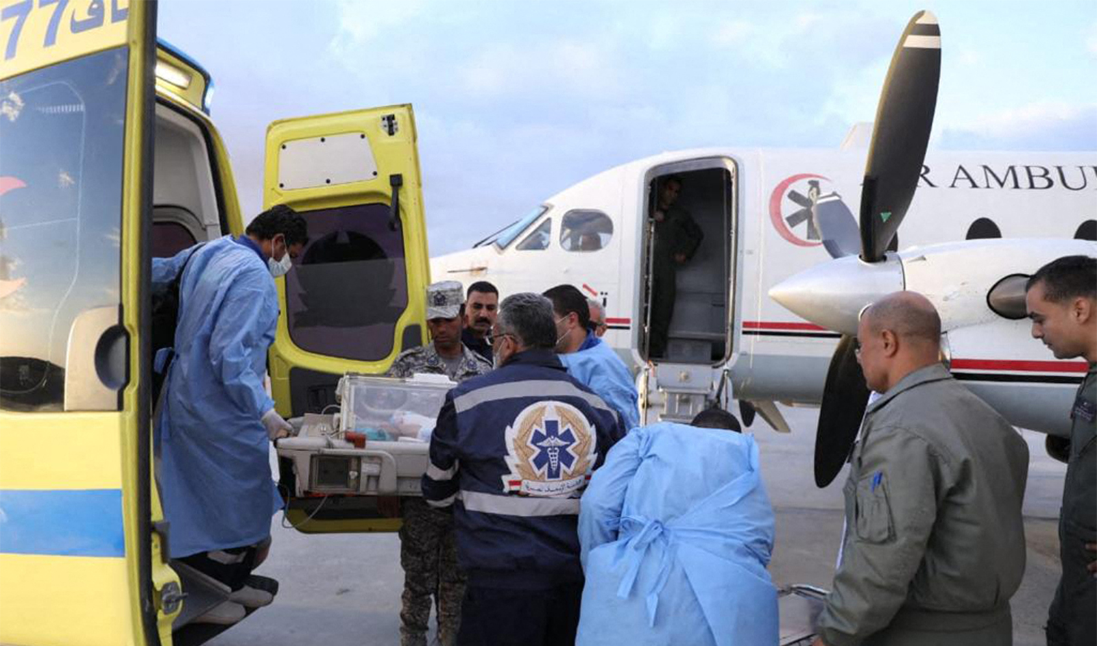 A handout picture taken by Egyptian health Ministry on November 20, 2023, shows medics transporting a premature Palestinian baby evacuated from Gaza into an Air Ambulance at Egypt's al-Arish Airport, heading to the New Capital Hospital in Cairo. (AFP/File)