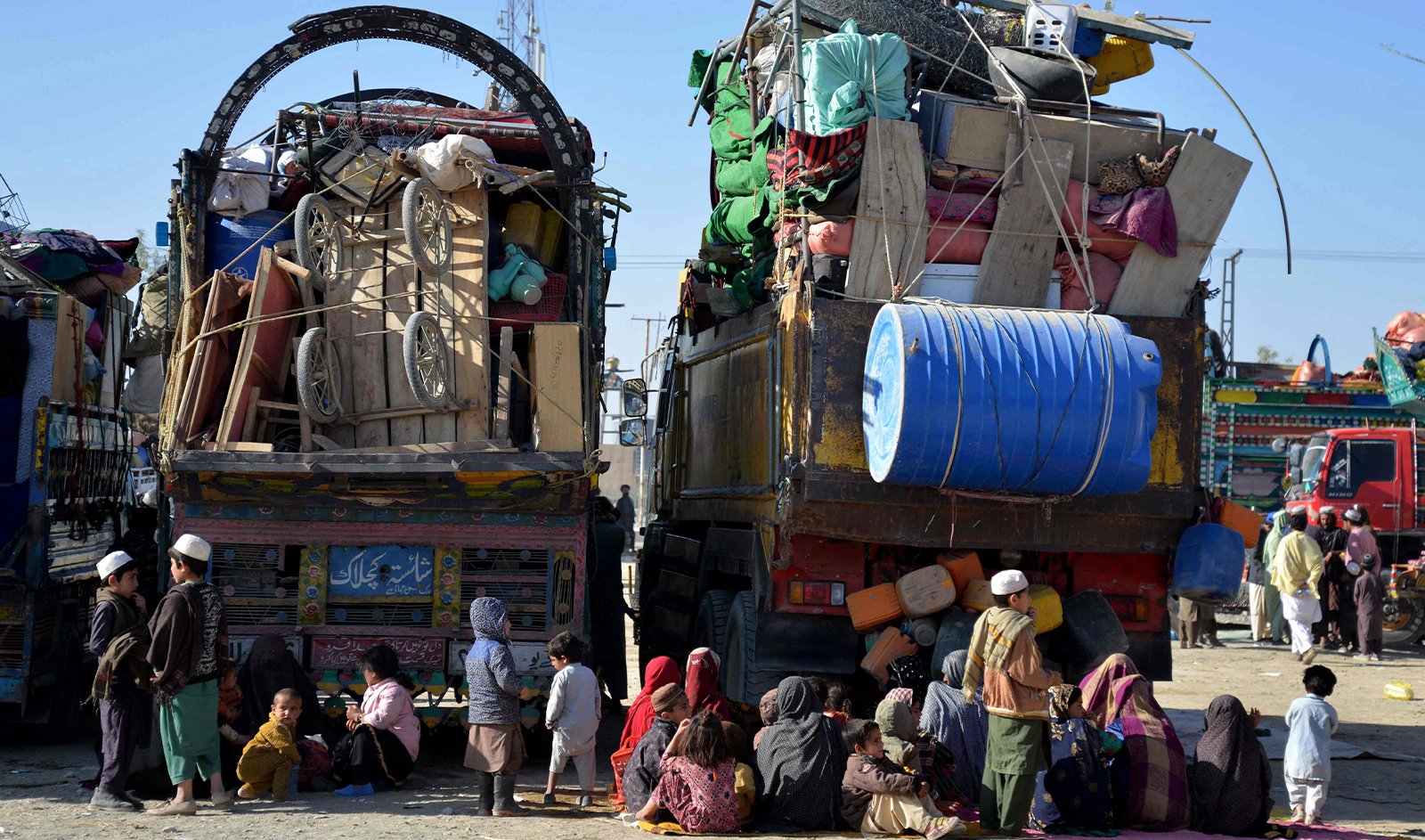 Afghan refugees sit beside their belongings at a registration centre upon their arrival from Pakistan, near the Afghanistan-Pakistan border in the Spin Boldak district of Kandahar province on November 20, 2023. (AFP)