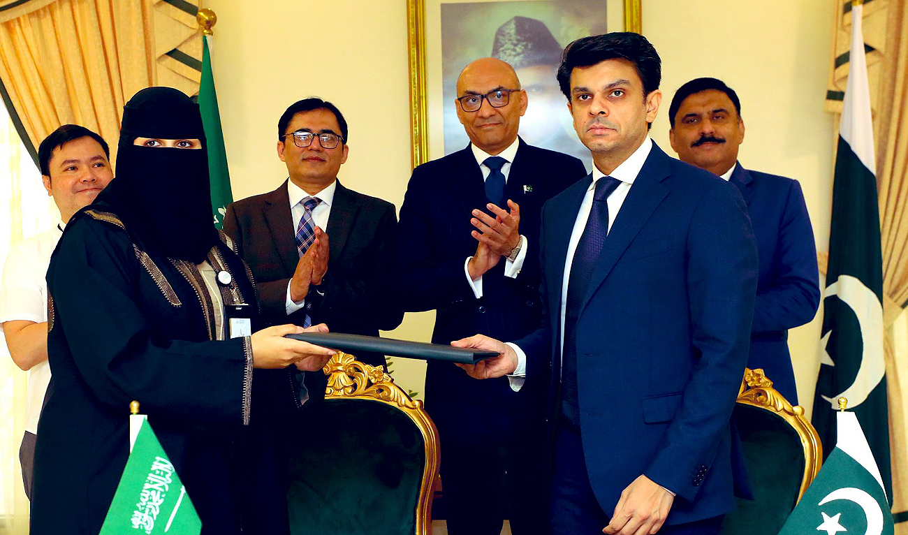 This handout photo, taken and released by the Ministry of Overseas Pakistanis and Human Resource Development, shows Special Assistant to the Prime Minister, Jawad Sohrab Malik (right), after signing letter of intent with Saudi recruitment agency Maharah Human Resources to unlock jobs for Pakistani nationals in Riyadh on November 25, 2023. (Photo courtesy: GOP)