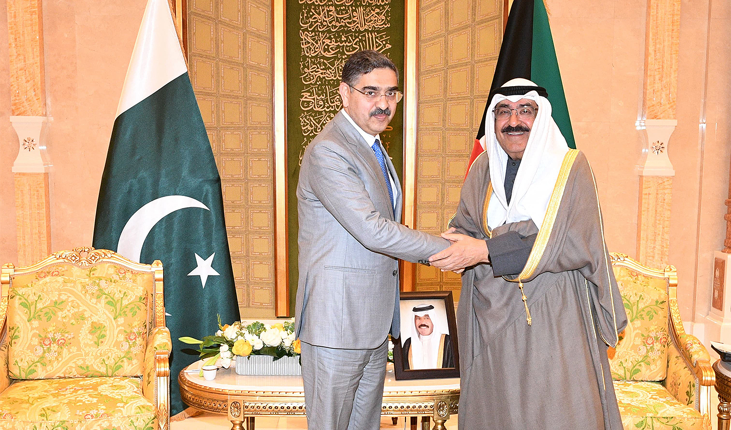 Pakistan's Caretaker Prime Minister Anwaar-ul-Haq Kakar (left) shakes hands with Crown Prince Sheikh Mishal Al-Ahmad Al-Jaber Al-Sabah in Kuwait on November 29, 2023. (Government of Pakistan)