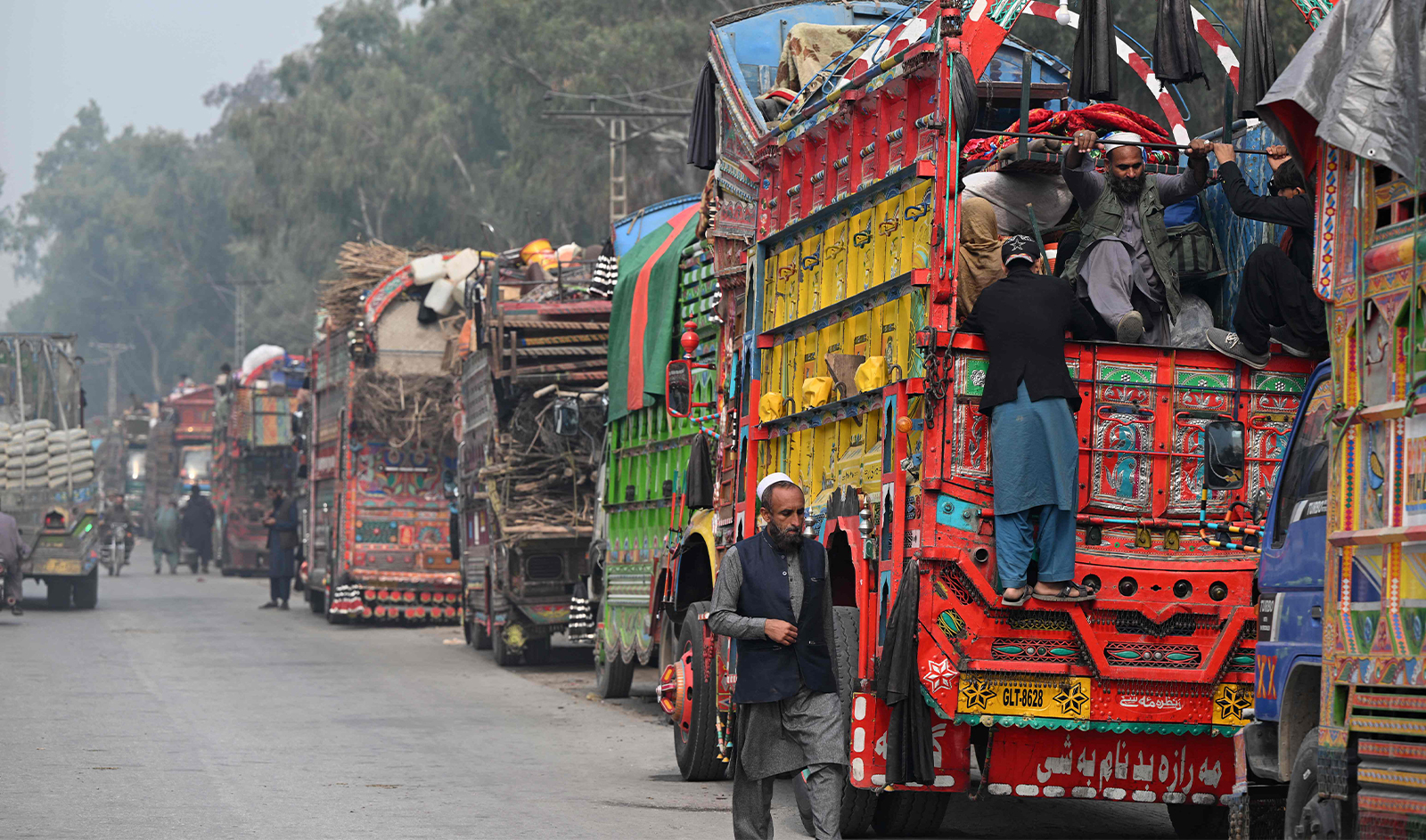 This photo taken on November 23, 2023 shows Afghan refugee on a truck after visiting the United Nations High Commissioner for Refugees (UNHCR) Azakhel Voluntary Repatriation Centre in Nowshera, Pakistan. (AFP/File)
