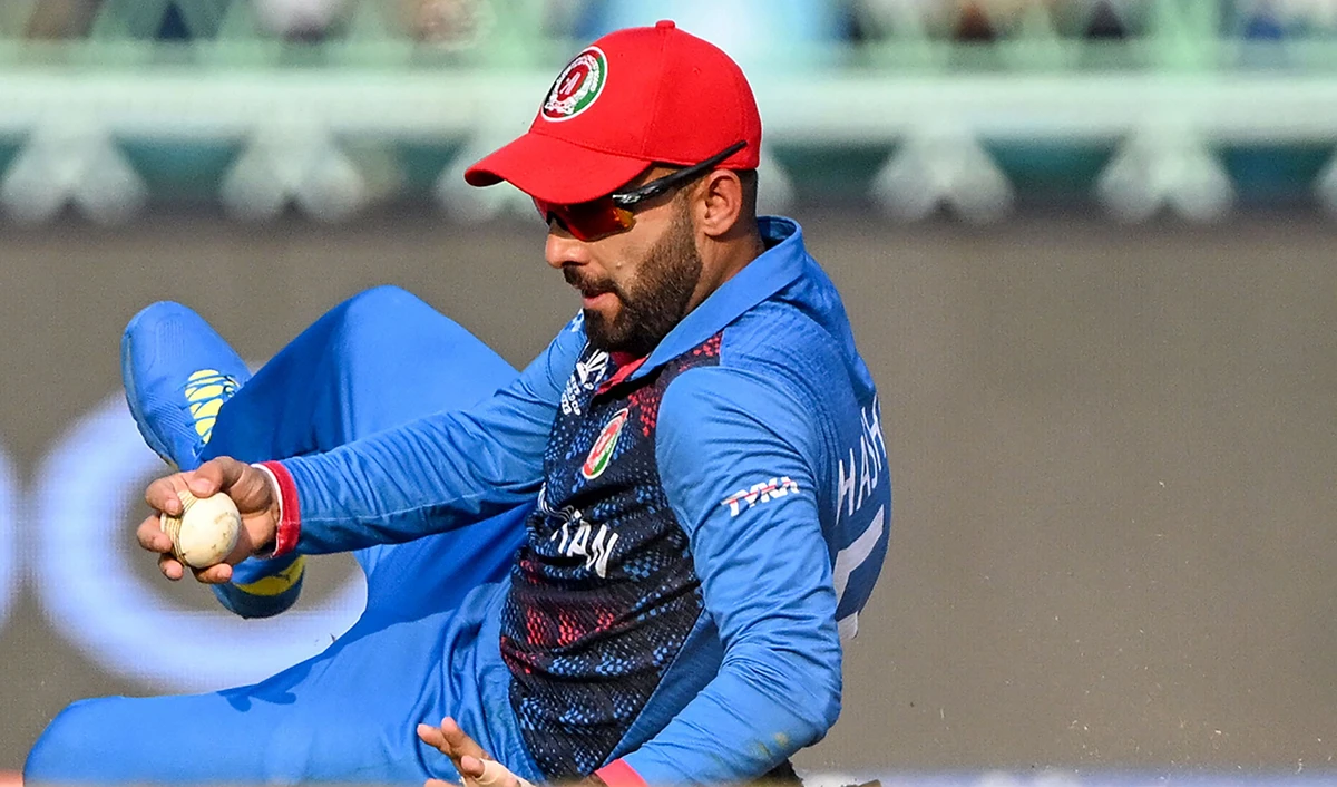 Afghanistan's captain Hashmatullah Shahidi stops the ball during the 2023 ICC Men's Cricket World Cup one-day international (ODI) match between Netherlands and Afghanistan at the Ekana Cricket Stadium in Lucknow on November 3, 2023. (AFP)