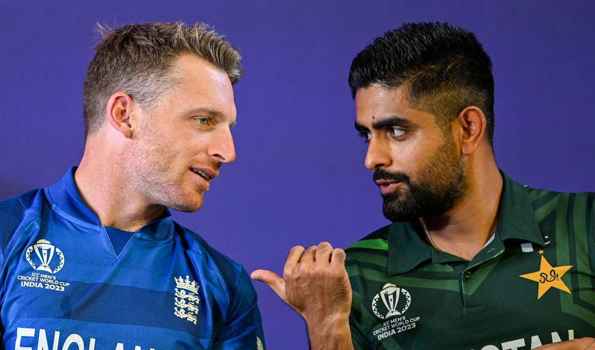 Pakistan's captain Babar Azam (R) speaks with his England counterpart Jos Buttler during the 'Captains' Day event' an interaction session between the captains of all participating teams and the media at the Narendra Modi Stadium in Ahmedabad on October 4, 2023. (AFP/File)