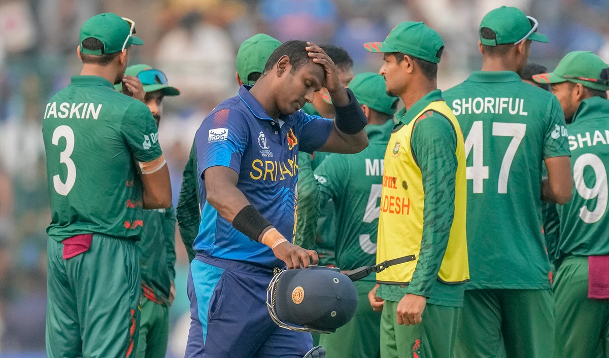 Sri Lanka's Angelo Mathews, foreground walks off the field after he was declared timed out during the ICC Men's Cricket World Cup match between Bangladesh and Sri Lanka in New Delhi, India, on November 6, 2023. (AP)