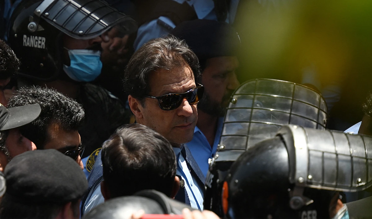 Police cammandos escort former Pakistan's Prime Minister Imran Khan (C) as he arrives at the high court in Islamabad on May 12, 2023. (AFP/File)