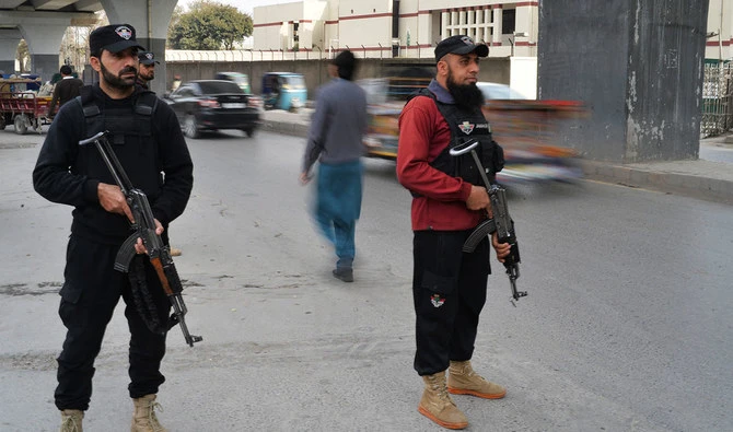 Policemen stand guard along a street in Peshawar on February 1, 2023, days after a mosque suicide blast inside a police headquarters. (AFP/File)