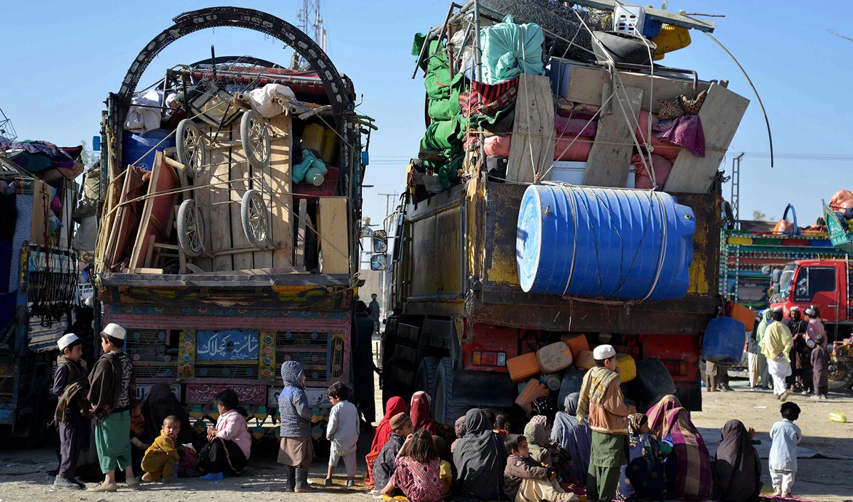 Afghan refugees sit beside their belongings at a registration centre upon their arrival from Pakistan, near the Afghanistan-Pakistan border in the Spin Boldak district of Kandahar province on November 20, 2023. (AFP)