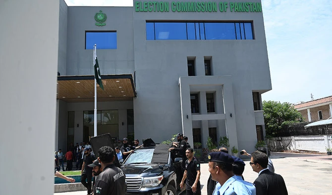 In this file photo, taken on July 25, 2023, security personnel escort a vehicle carrying Pakistan’s former Prime Minister Imran Khan (C) as he leaves after appearing before the Election Commission in Islamabad. (AFP/File)