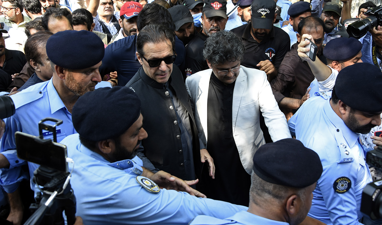 Former Pakistani Prime Minister Imran Khan, center, arrives to the Islamabad High Court surrounded by journalists and security in Islamabad, Pakistan, on September 8, 2022. (AP)