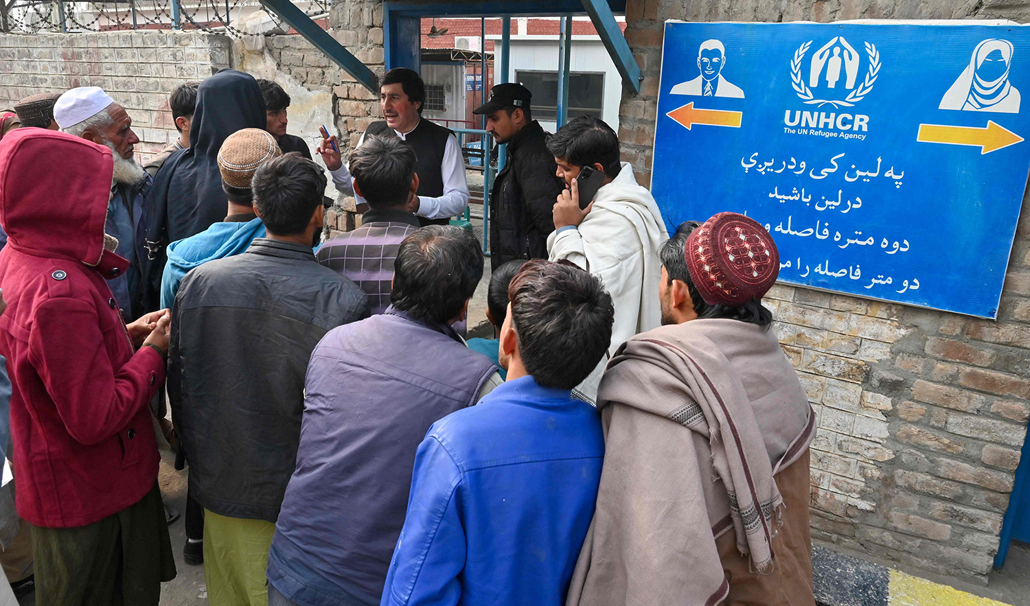 An employee of the UNHCR preparing Afghan refugees for verification at the United Nations High Commissioner for Refugees (UNHCR) Azakhel Voluntary Repatriation Centre in Nowshera, Pakistan on November 23, 2023. (AFP/File)