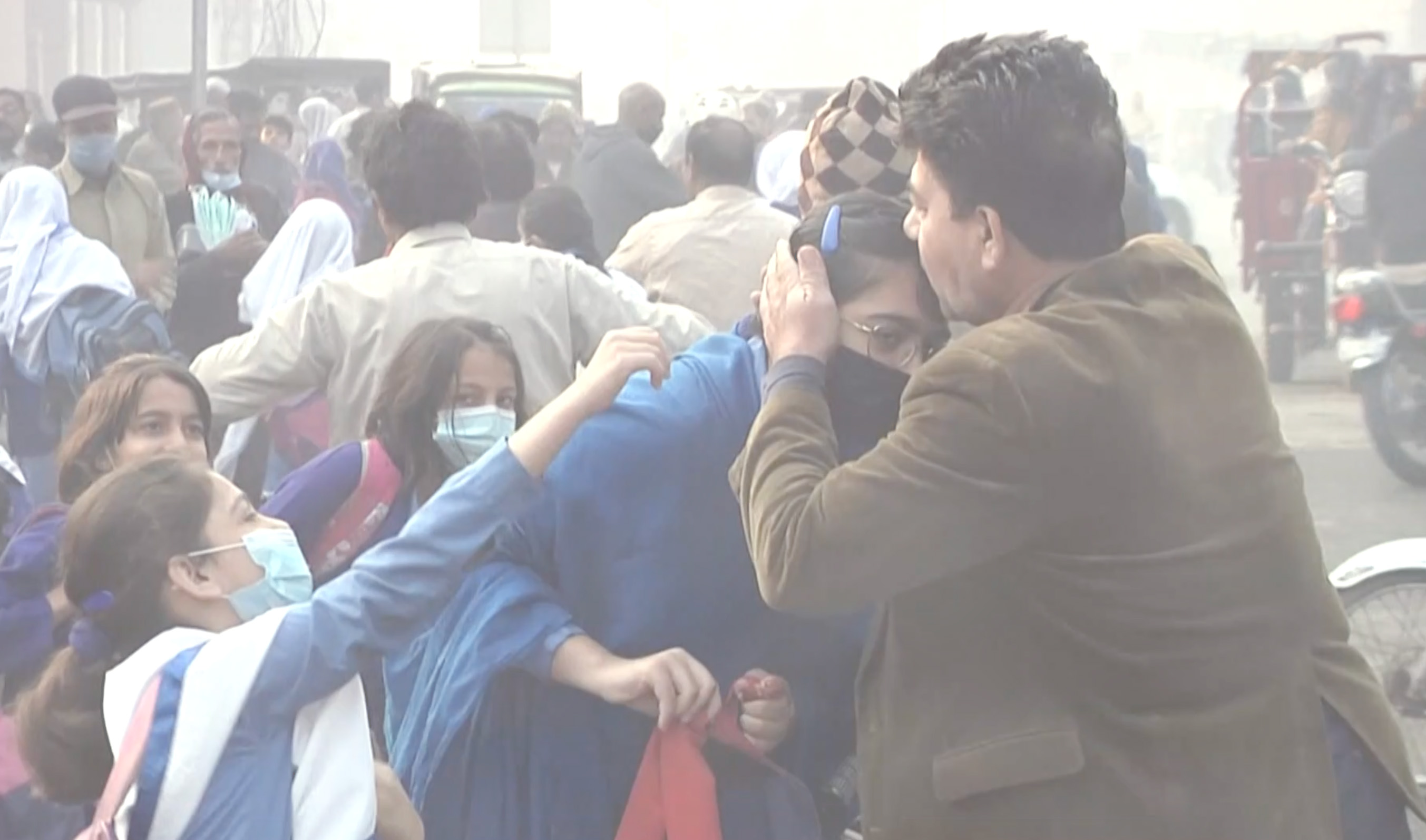 A Pakistani man kisses his daughter after dropping her to the school in Lahore, Pakistan on December 1, 2023. (AN photo)