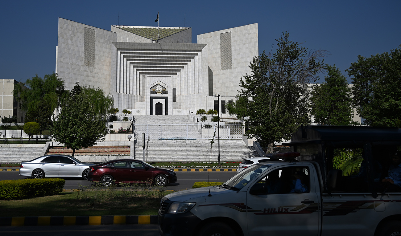 Motorists drive past Pakistan's Supreme Court in Islamabad on April 5, 2022. (AFP/File)