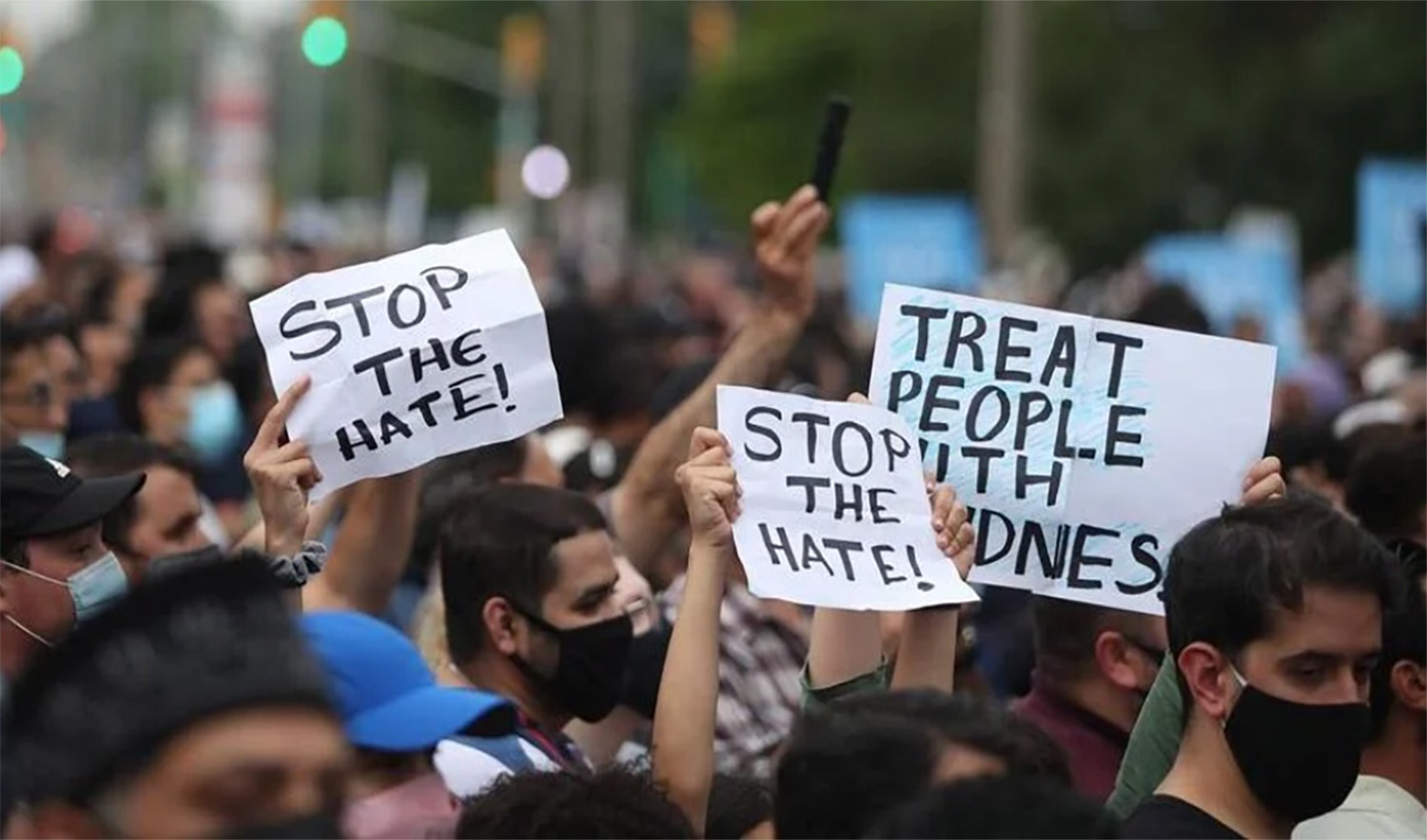 Londoner's hold placards as they attend a vigil for the victims of the deadly vehicle attack on five members of the Canadian Muslim community in London, Ontario, Canada, on June 8, 2021. (AFP/File)
