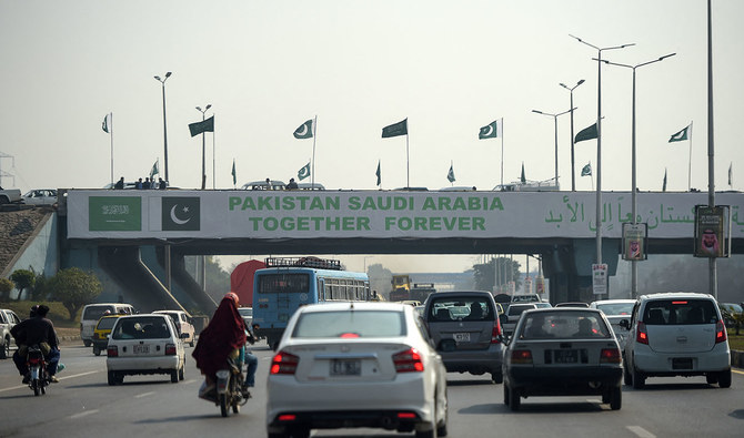 Pakistani commuters drive their vehicles under a banner welcoming Saudi Arabian Crown Prince Mohammed bin Salman displayed on a bridge, ahead of his arrival, in Islamabad on February 15, 2019. (AFP/File)