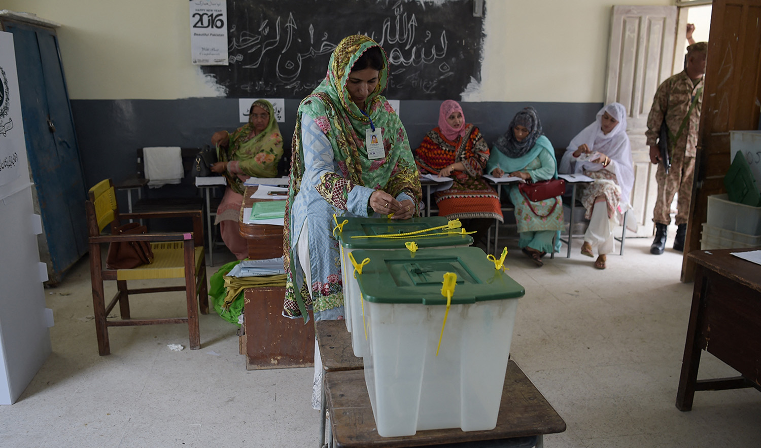 An election official seals ballot boxes before people vote during Pakistan's general election at a polling station in Islamabad on July 25, 2018. (AFP/File)