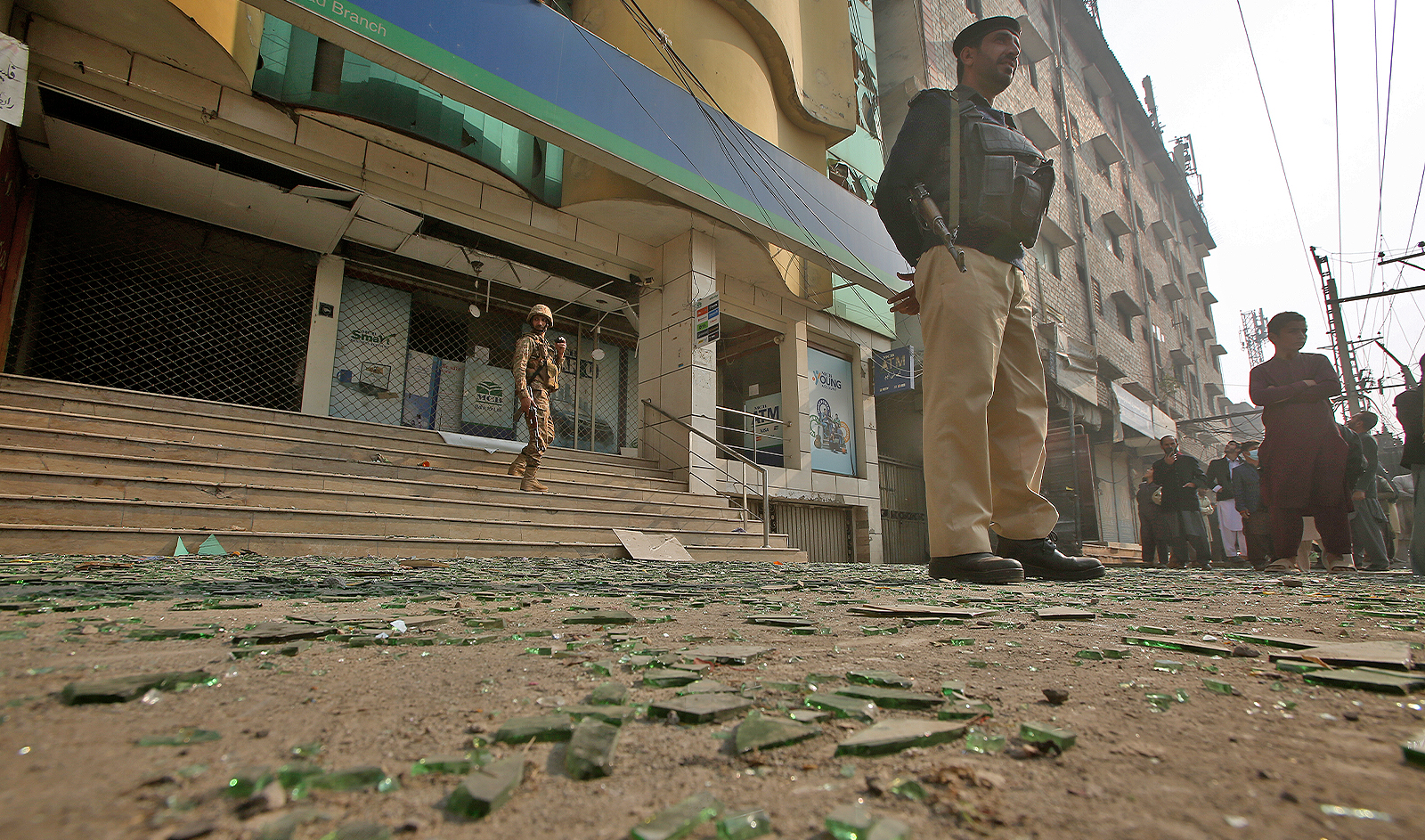 Security officials and local gather near the site of a bomb explosion, in Peshawar, Pakistan, on December 5, 2023. (AP)